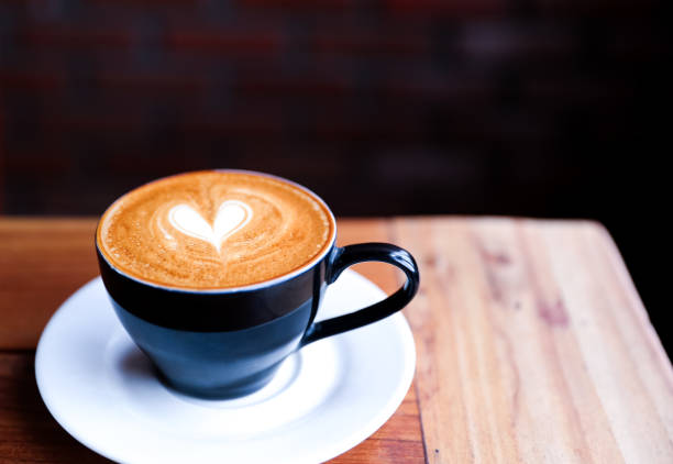 istock Cappuccino cup with heart latte art on wooden table background. 1066002206