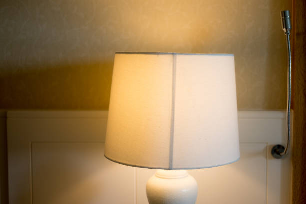 istock Bedside lamp on night in hotel bedroom 1066013490