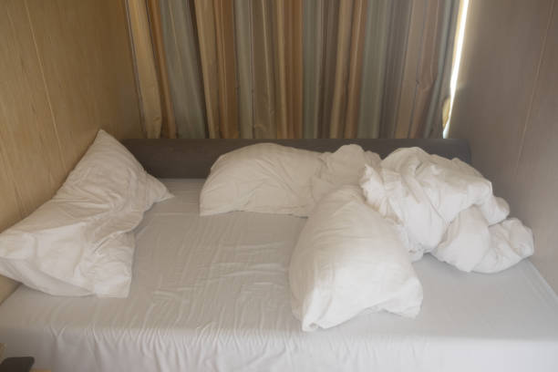 istock Bed sheet and pillows messed up in hotel 1066013498