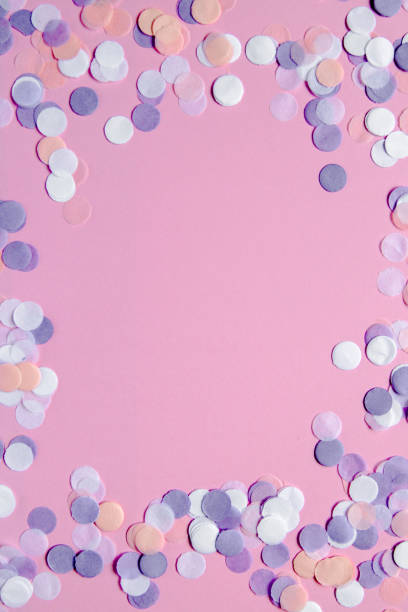 istock Multicolored confetti on pink background. Festive concept. 1066016320