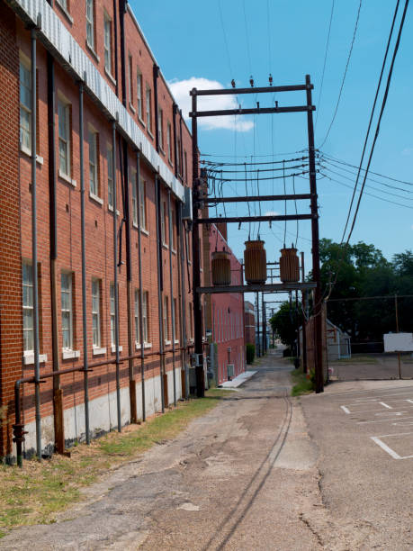 istock Alley behind brick buildings with power lines 1066024048