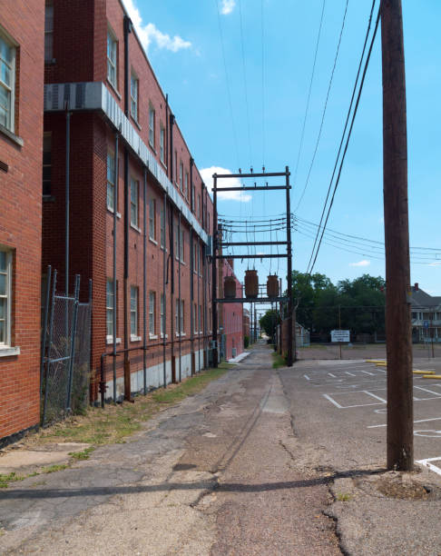 istock Alley behind brick buildings with power lines 1066024050
