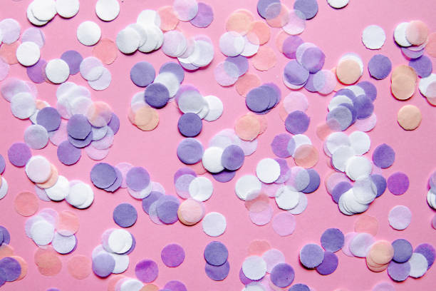 istock Multicolored confetti on pink background. Festive concept. 1066034682