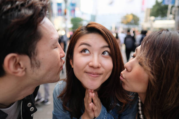 Closeup three friends's faces Three friends on the street of Shibuya, Tokyo three way kiss stock pictures, royalty-free photos & images