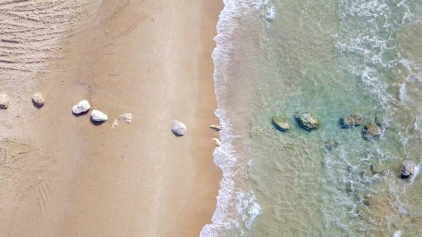 istock Aerial image of waves breaking on a tropical beach 1066065068