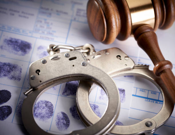 istock Gavel and handcuffs on fingerprints: Arrest crime concept 1066067004