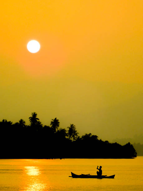 Sunset started earlier in Pahawang Island because west side of this island is covered with mountains.when it's sunset time, the sky can be so orange. a local on the boat making the picture more dramatic.