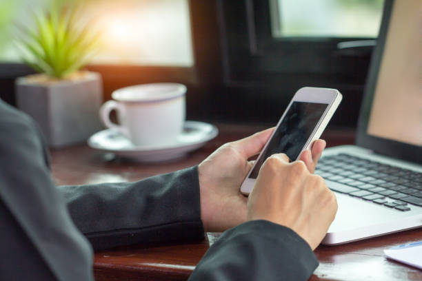 istock business man hand working on smart phone and laptop computer 1066082796
