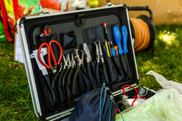 istock Black toolbox with a set of pliers lying in the grass 1066082984