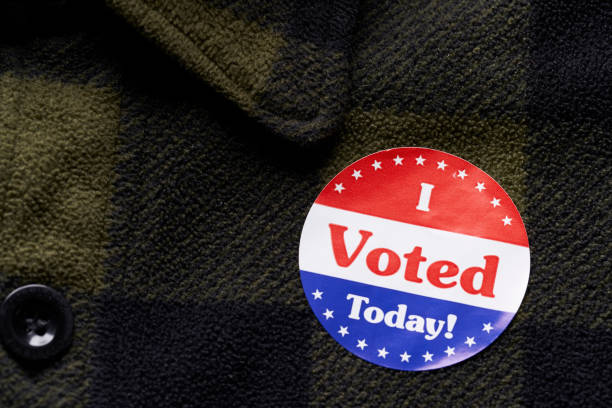 istock I VOTED sticker on man's flannel shirt 1066084350