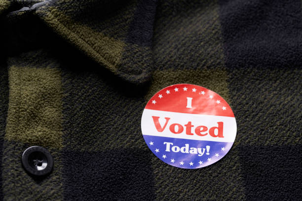 istock I VOTED sticker on man's flannel shirt 1066084376