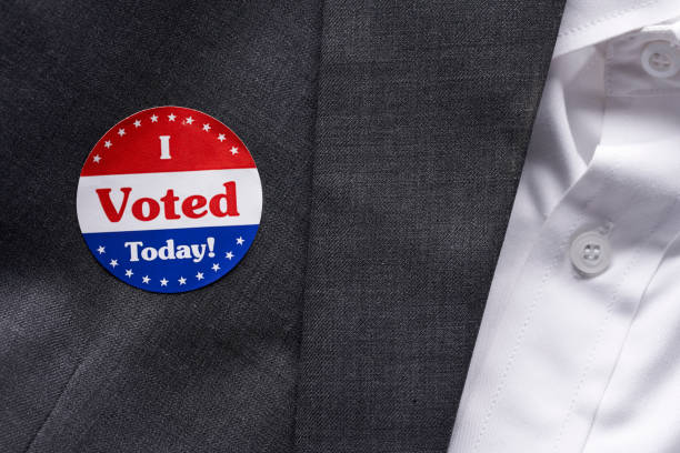 istock I VOTED sticker on man's suit jacket 1066084418