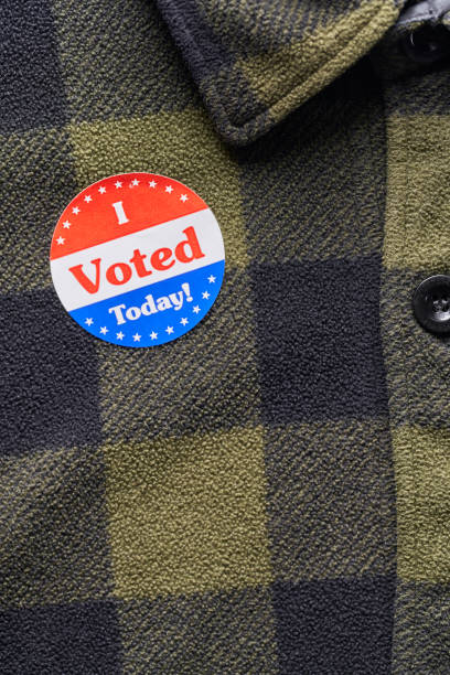 istock I VOTED sticker on man's flannel shirt 1066084626