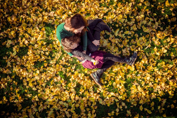 istock Mother with daughter under a ginkgo tree in autumn 1066089682