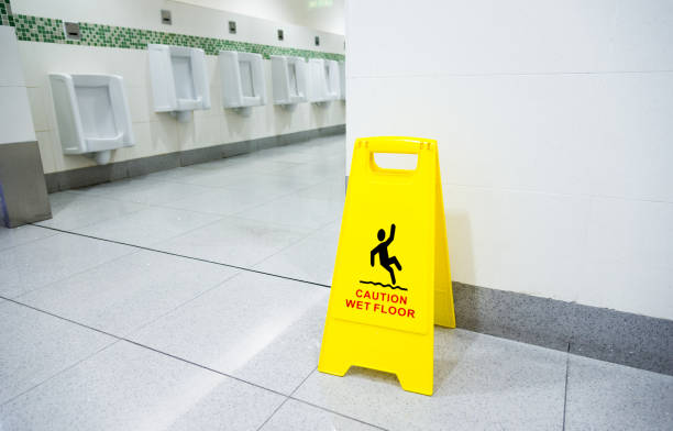 Yellow caution wet floor sign in public restroom