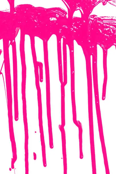 Close up of pink paint leaking isolated on white background