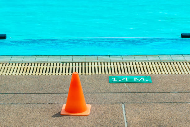 istock 1.4 meter depth sign and small plastic orange cone at an outdoor swimming pool 1066096428