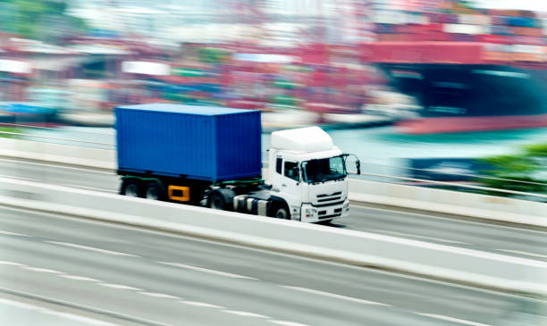 istock Blue truck leaving the harbor 1066100910