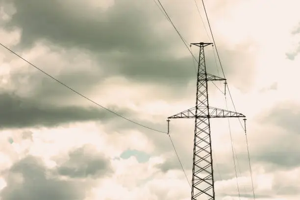 pole with power line and insulators against the sky
