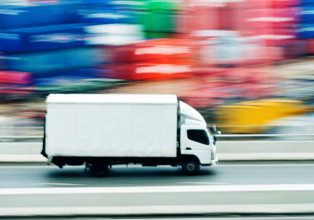 istock White truck leaving the harbor 1066103582