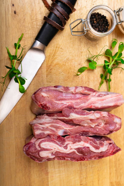 istock Raw lamb meat with spices on a wooden background. 1066107094