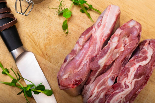 istock Lamb - mutton - with greenery on wooden board. Top view. 1066107096