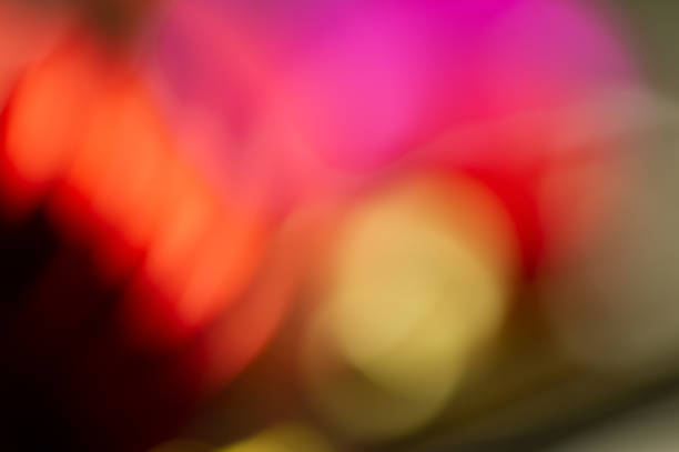 istock holiday lighting effects of different colors and spots on a light background. Blurred background. 1066109902