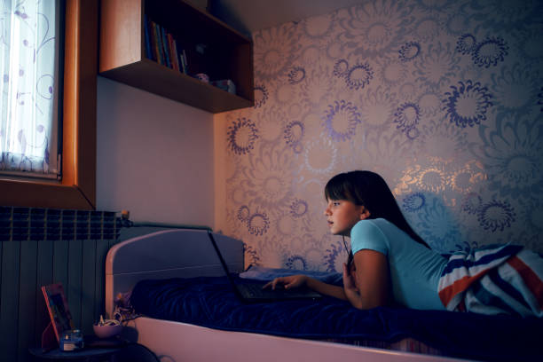istock Girl  sitting  with her laptop on a bed 1066113382