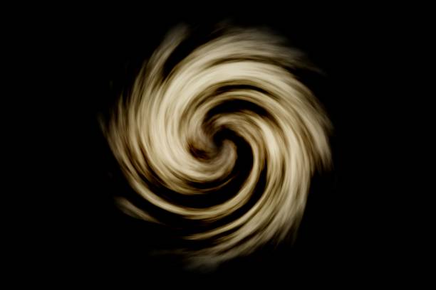 istock Abstract spiral galaxy with light brown smoke on black background 1066126962