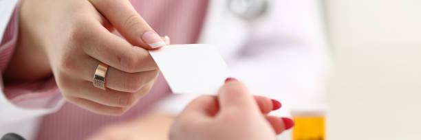 istock Female physician hand give white blank 1066132172