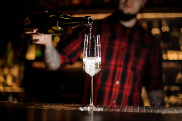 istock Barman pouring champagne into an elegant glass 1066136512