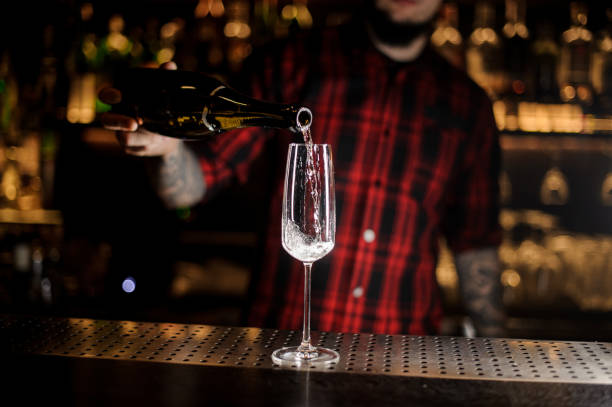 istock Bartender pouring champagne into an elegant glass 1066136568