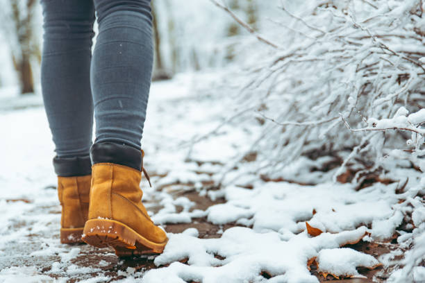 istock woman winter boots on snow close up 1066141782