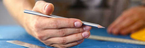 istock Male hand holding pencil in hand. 1066145820