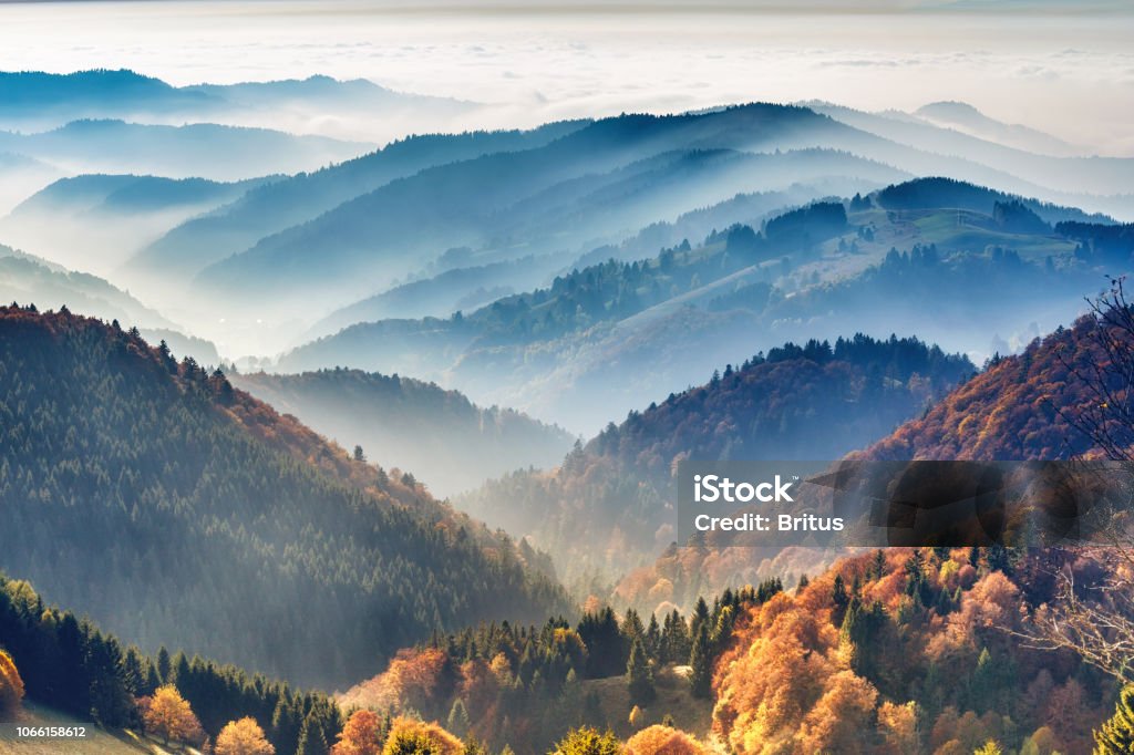 Scenic mountain landscape. View on Black Forest in Germany, covered in fog Scenic mountain landscape. View on the Black Forest, Germany, covered in fog. Colorful travel background. Black Forest - Germany Stock Photo