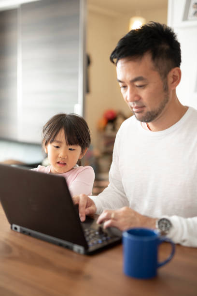 istock Father working from home with daughter 1066159856