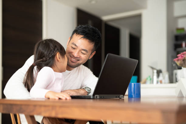 Father working from home with daughter Everyday life of father and daughter at home role reversal stock pictures, royalty-free photos & images