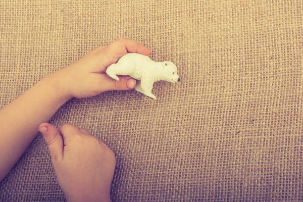 istock Hand holding a Polar bear model in hand 1066161134