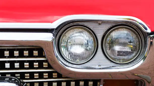 Photo of Front headlight of an old retro retro car. Close-up. Motor transport.