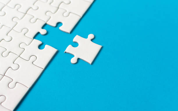 istock White jigsaw puzzle on blue background. Team business success partnership or teamwork. 1066165624