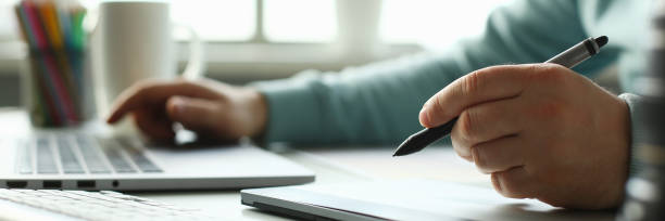 istock A young designer holds a pen from a tablet in his 1066167024