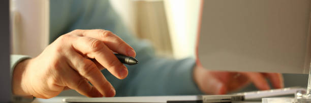 istock A young designer holds a pen from a tablet in his 1066167090