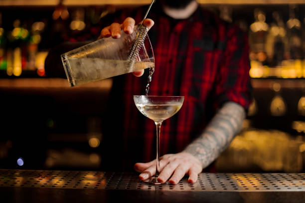istock Bartender pouring a Twinkle alcoholic cocktail from the measuring cup 1066167190