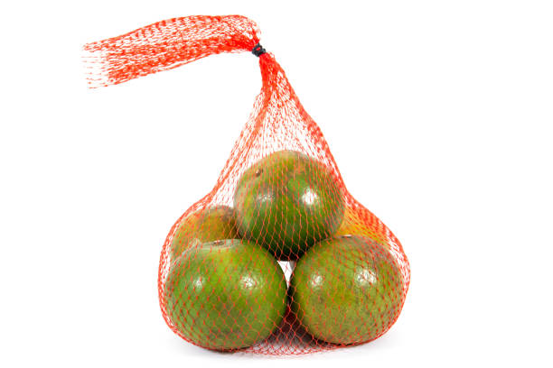 istock Orange fruit in carry net bag isolated on white background 1066167472