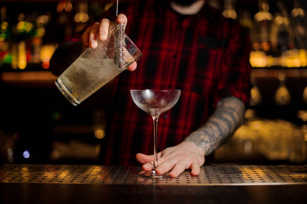 istock Bartender pouring a Twinkle alcoholic drink from the measuring cup 1066167720