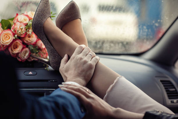 Woman's legs on the front and wedding bouquet