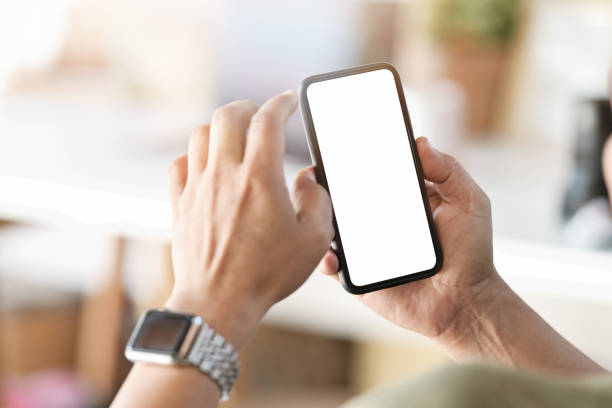 istock Male hand holding blank screen mobile phone in office. 1066173868