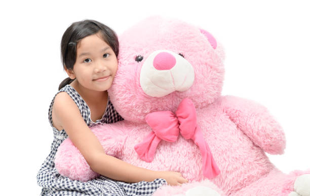 istock Cute girl hugging pink teddy bear isolated 1066174834