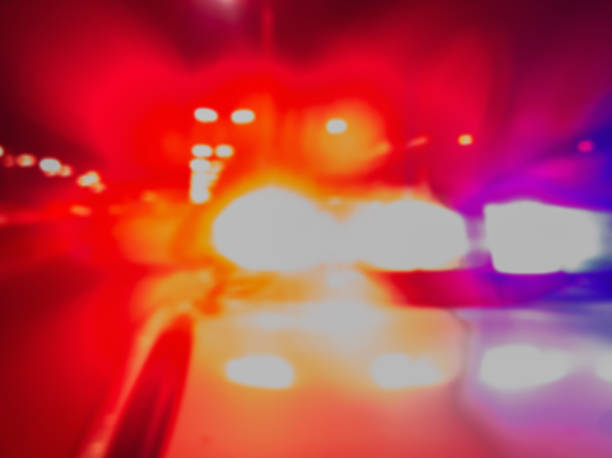 Police car lights in night time for crime news and accidents. Crime scene, night patrolling the city. Abstract blurry image. Red and blue Lights of police car in night time, crime scene. Night patrolling the city. Abstract blurry image. police vehicle lighting photos stock pictures, royalty-free photos & images