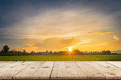 Rice field sunset and Empty wood table for product display and montage.